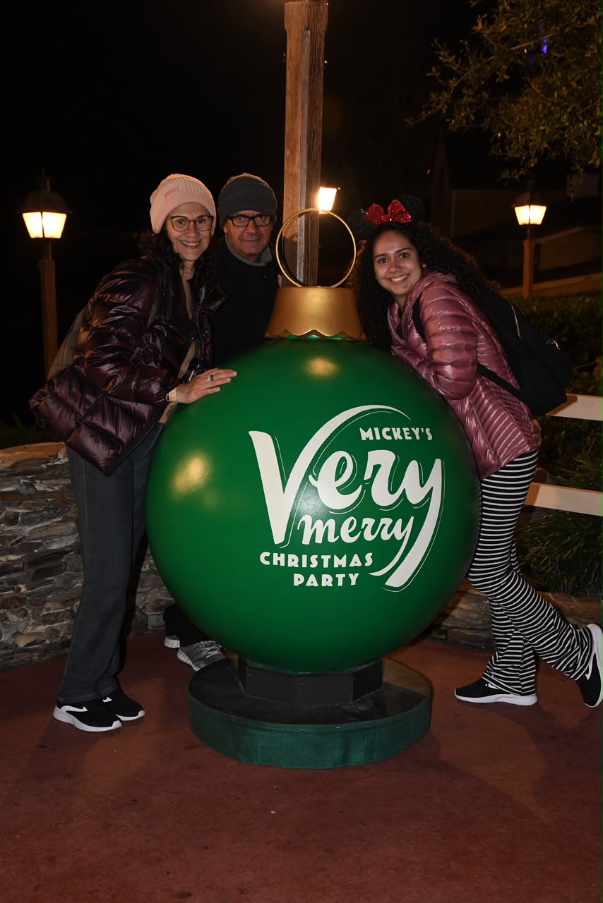 Visitantes posam ao lado do enfeite gigante da Mickey's Very Merry Christmas Party durante a festa de Natal no Magic Kingdom, no Walt Disney World, em Orlando